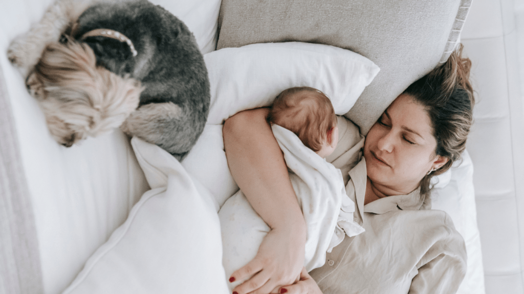 Mom and baby sleeping on bed