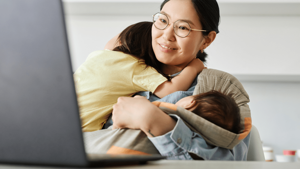 Mom carrying her kids while doing online