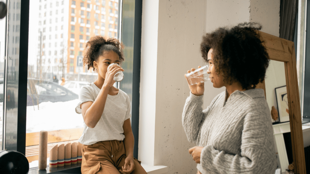 Mom and daughter drinking water